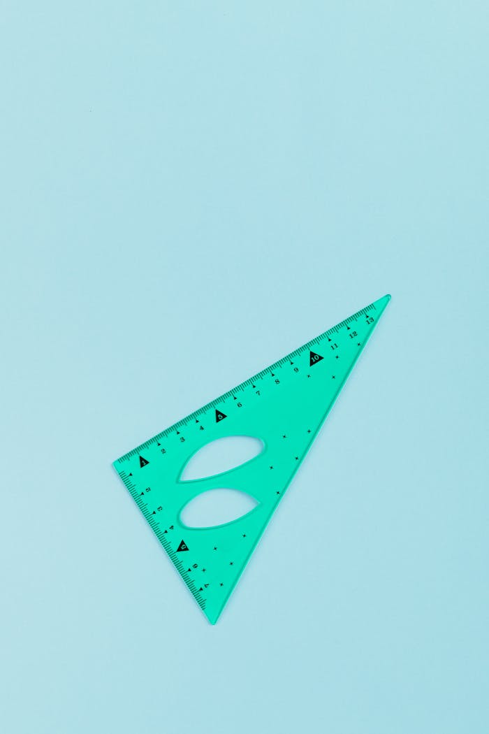 A turquoise set square on a light blue background, ideal for educational or geometric themes.